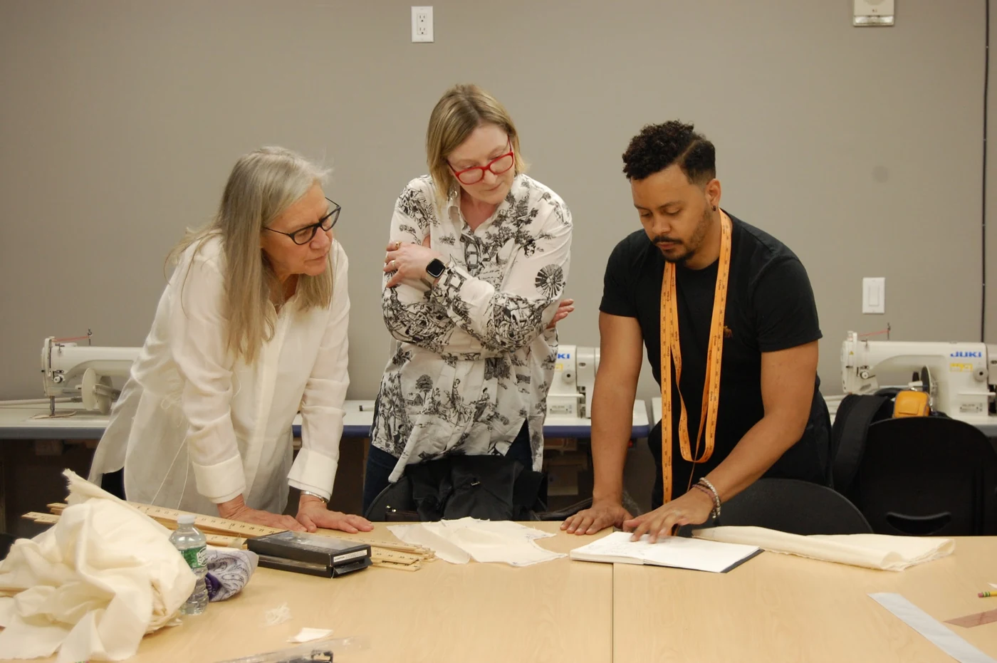 Participants working together on garment patterns